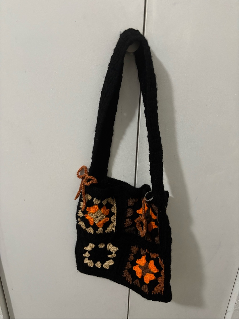 Handcrafted Black Crochet Shoulder Bag with Orange Floral Accents